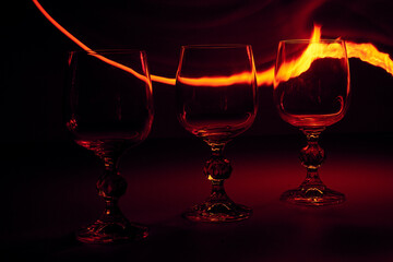 glass of wine with fire line on background