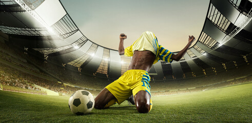 Winner, victory. Professional football player on sport football arena celebrating a goal at 3D model sport stadium arena. Champion, winner emotions. Concept of sport, energy, achievements, success, ad