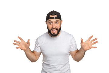 Portrait of young middle eastern bearded man with white t-shirt and the hat on backwards looking at camera. The man posing with his arms wide open. Studio shot, isolated on white background.