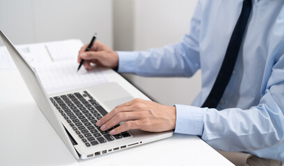 Business man working by using laptop computer Hands typing on a keyboard. Professional investor working new start up project. business planning in office. Technology business