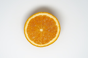 Slice of ​​orange on white isolated studio background top view
