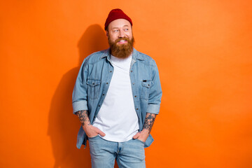 Photo of stylish wearing outfit young irish man masculine redhair beanie cap hands pockets look mockup open store isolated on orange color background