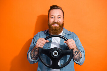 Photo of cheerful positive guy dressed denim jacket rising driving car fast isolated orange color background