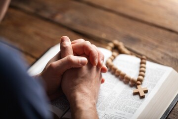 Man hands praying on the bible. Concept religion