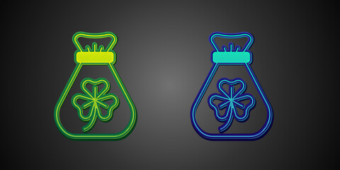 Green and blue Money bag with clover trefoil leaf icon isolated on black background. Happy Saint Patricks day. National Irish holiday. Vector
