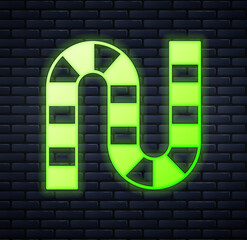 Glowing neon Board game icon isolated on brick wall background. Vector