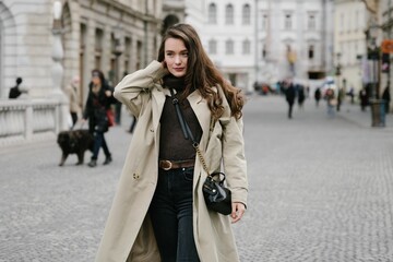 Fototapeta premium Young beatiful woman portrait in the historical city centre of Ljubljana in trendy outfit