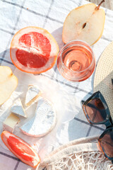 Romantic sunset dinner on the beach. Table honeymoon set for two with luxurious food, glasses of rose wine drinks in a restaurant with sea view. Summer love, romance date on vacation concept.   