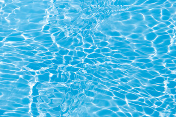 Defocus blurred transparent blue colored clear calm water surface texture with splashes and bubbles. Trendy abstract nature background. Water waves in sunlight with copy space. Blue water shine