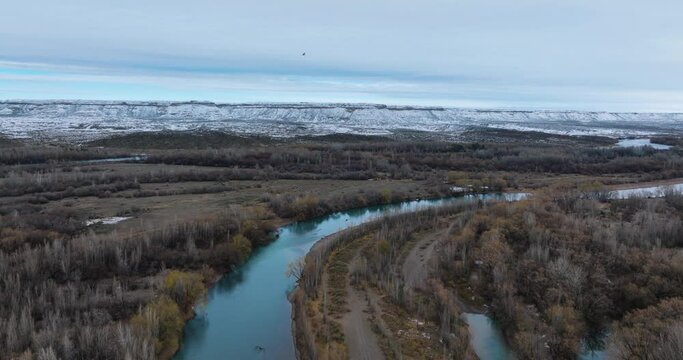 Snowfall in Rio Negro river and cliffs in winter. Alto Valle, Rio Negro, Patagonia Argentina