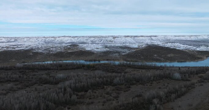 Winter snowfall in the cliffs by the Rio Negro river. Aerial view. Patagonia, Argentina