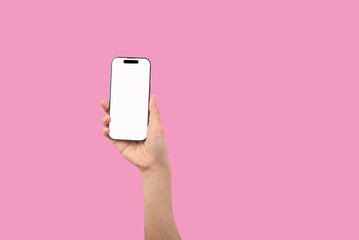 Fototapeta na wymiar Smartphone in female hands taking pictures isolated on pink background