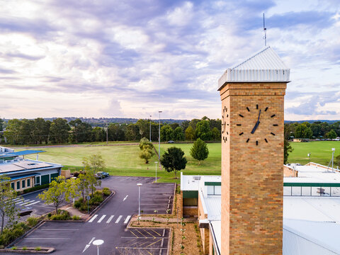 Council building with clock tower at dusk with pastel purple clouds