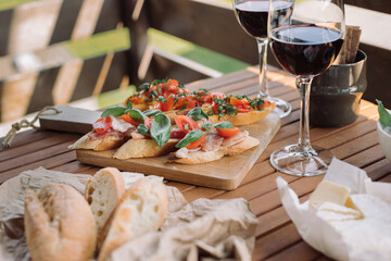 Bruschetta with tomato and basil, wine. Snacks and drinks for summer party.