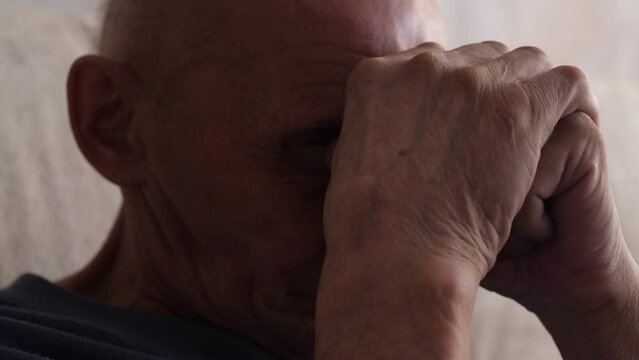 portrait of a caucasian pensioner praying with closed eyes, an elderly believer. faith in God concept. real pensioners. emotions of the elderly