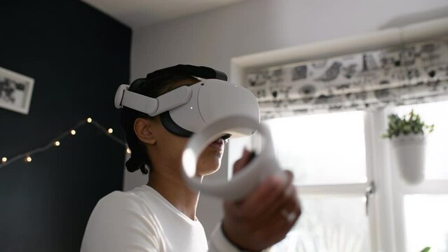 Teen girl using Virtual Reality headset and controls