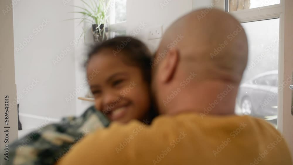 Wall mural Multiracial father hugging son with Down syndrome