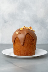 Ester cake with chocolate topping and nuts on gray background