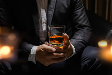 businessmen holding a glass of whiskey