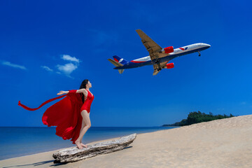 Vacationers take photo at Mai khao beach. The plane is down at Phuket International Airport.