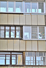 Fragment of the facade of a multi-storey residential building on a spring day