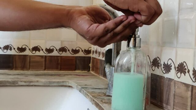 Footage of a person washing hands with soap. Hand washing is important for protection from Corona virus. Corona XBB1.16 new Strain of corona virus.