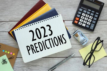 2023 Predictions text on a notepad, three notepads on the desktop. conceptual background
