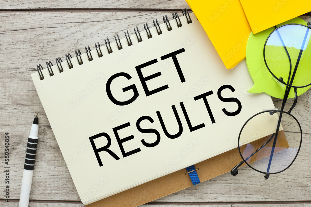Aufkleber get results wooden background with open notepad with text. yellow stickers and glasses near the text