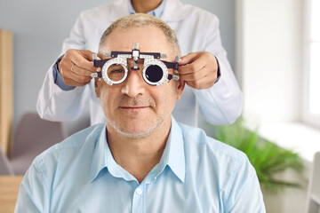 Optometry specialist doing eye test during checkup consultation visit. Optometrist or...