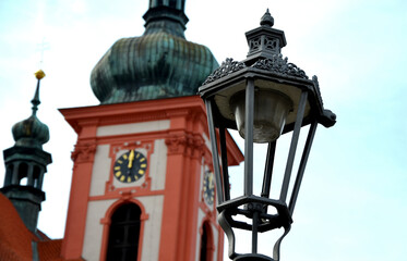 Historicizing style of lamp that is not gas but LED lights. Lantern frame without glass filling. historic city center with natural facade brown wooden door with arch