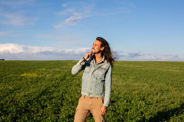 Long hair man in green meadow