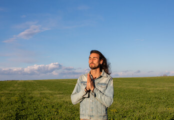 Long hair man in green meadow