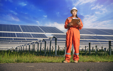Electrical, instrument technician survey, checking, maintenance electric system at the sunset solar panel field.