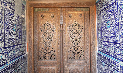 Complex carved wooden ornament on the doors