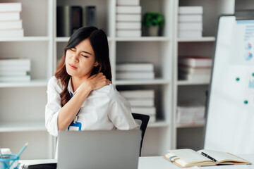 Young businesswoman are stressed and tired from work sitting at desk in the office, feeling pain at work, 