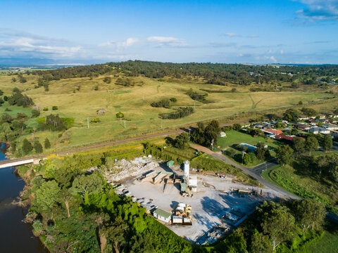 concrete factory plant with cement mixers beside railway and river