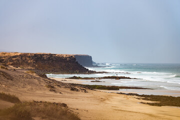 Stunning view of the El Cotillo beach with a rocky coastline in the distance. El Cotillo is situated on the northwest coast of Fuerteventura, Canary Islands, Spain.