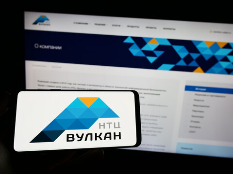 Stuttgart, Germany - 03-31-2023: Person holding cellphone with logo of Russian information technology company NTC Vulkan on screen in front of webpage. Focus on phone display.
