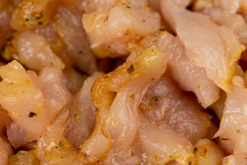 Sliced raw chicken fillet with spices