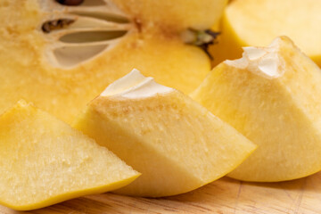 Sliced ripe yellow quince on a cutting board