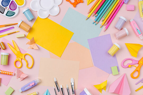 Pink pastel background with various colorful material for creativity and art activity.  Stationery and supplies for drawing and craft with .copy space.  Primary School or kindergarten.