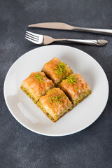 Pistachio Turkish baklava on a white plate.Traditional delicious Turkish baklava
