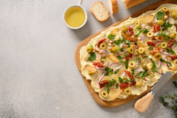 Homemade trendy Butterboard with onion, garlic, herbs, crispy baguette on gray background. Copy space. View from above.