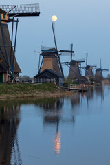 Moon over the historic windmills of Kinderdijk in Holland