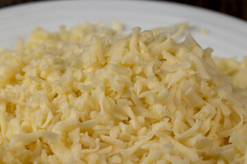 Hard cheese with holes grated into thin small slices
