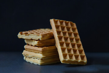 Belgian waffles on black stoneplate and black background