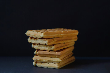 Belgian waffles on black stoneplate and black background
