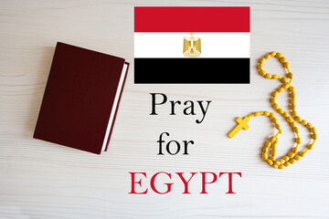 Pray for Egypt. Rosary and Holy Bible background.