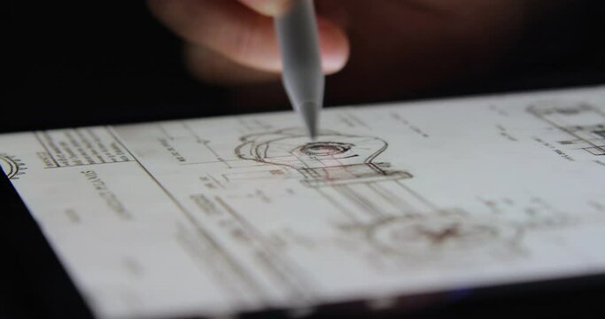 close up hand draw of schematics on a digital tablet with pencil