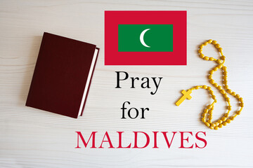 Pray for Maldives. Rosary and Holy Bible background.
